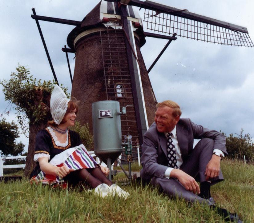 A Clemco blast machine sits in front of a windmill in Holland. After the creation of Hodge Clemco in England, Clemco established wholly owned subsidiaries throughout the world.